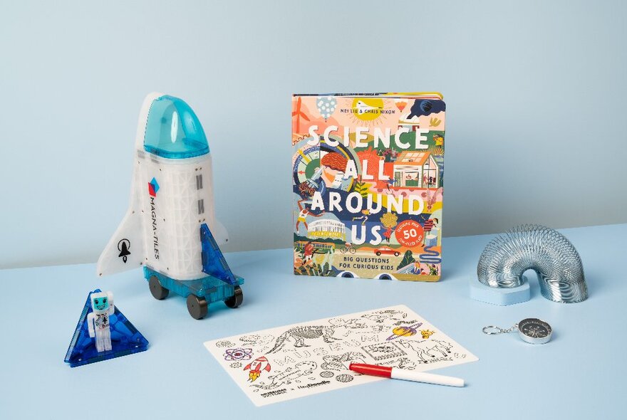 Museum shop items for sale including colouring a science book, rocket and slinky,