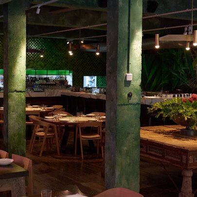 Dimly-lit restaurant with large wooden tables.
