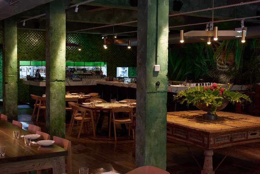 Dimly-lit restaurant with large wooden tables.