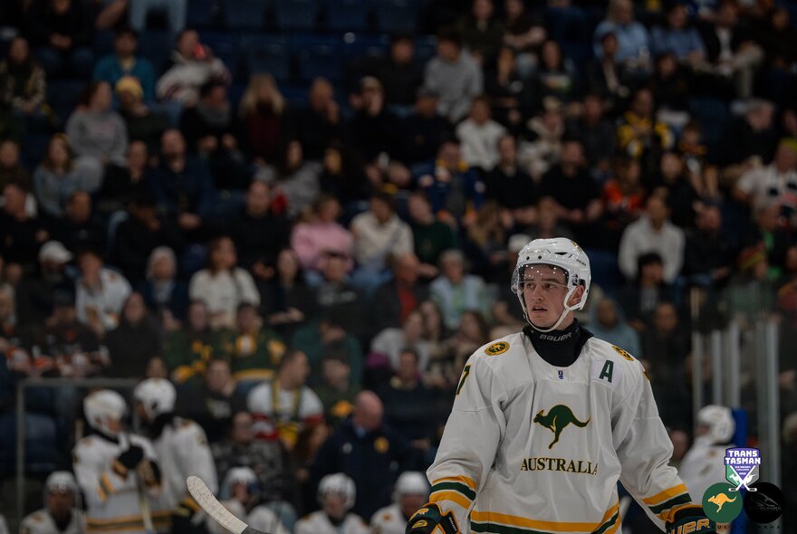 An Australian ice hockey player in front of the crowd.