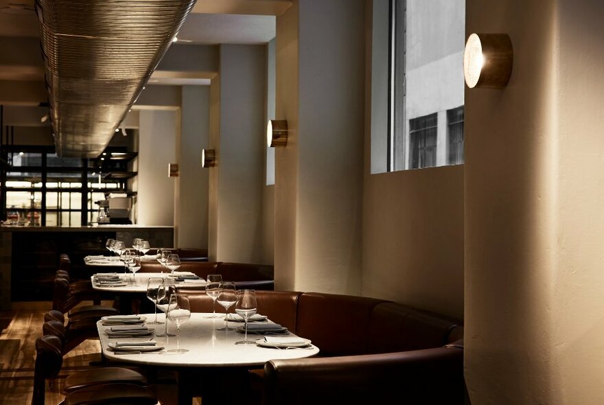 Interior of restaurant showing tables set and ready for dining patrons.