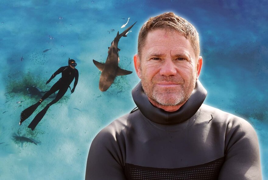 A portrait of Steve Backshall in a thick wetsuit, juxtaposed in front of an image of him swimming in the ocean with a large shark. 