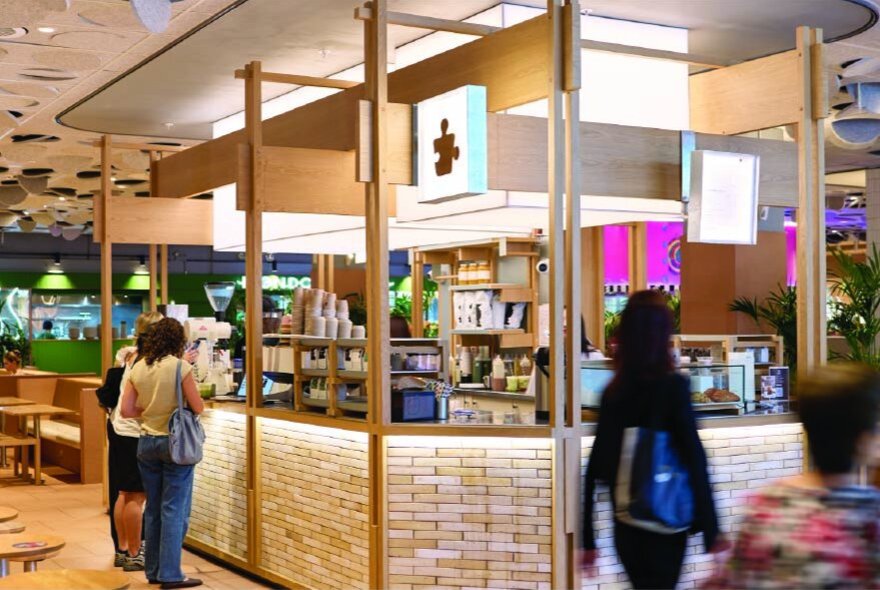 The counter of Puzzle Coffee with people waiting for a brew. 