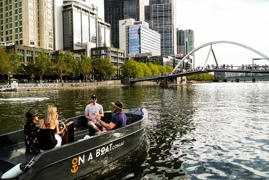 A group of people on a small boat on the Yarra River in Melbourne.