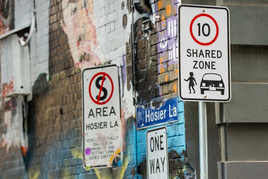 A Shared Zone sign and No Stopping sign next to Hosier Lane. 