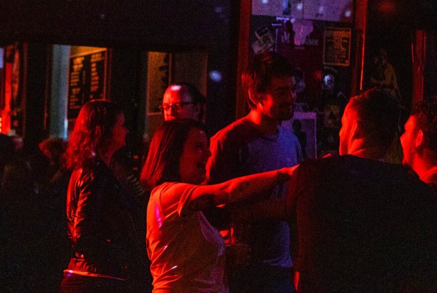 People socialising inside a bar.