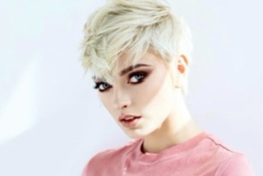 Woman displaying stylish haircut.