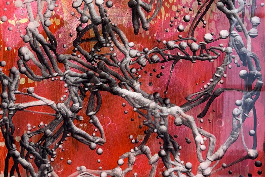 Abstract artwork of foliage on red background.