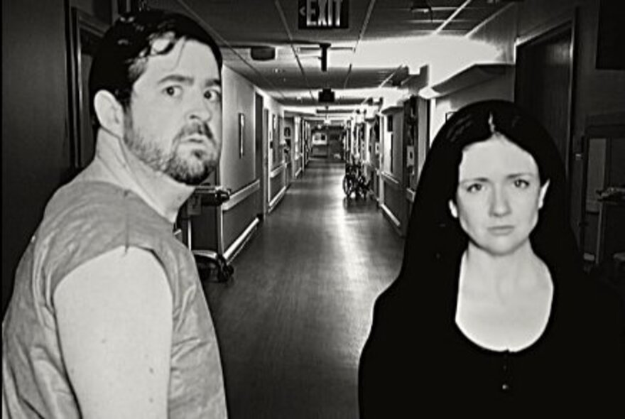Two people in a hospital corridor, looking scared.