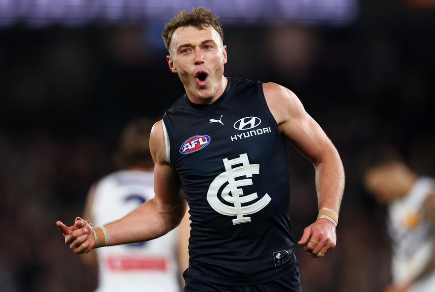 Carlton skipper Patrick Cripps celebrates a goal with a finger raised, mouth in an 'o' shape.