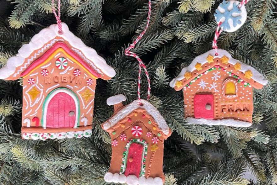 Gingerbread house Christmas decorations made from polymer clay.