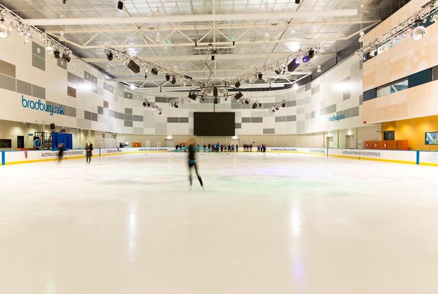 People skating on an ice rink.