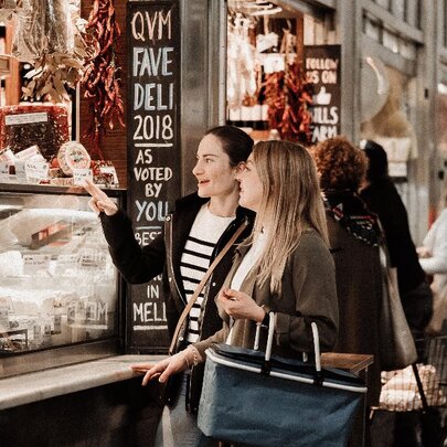 People lined up at a cheese stall at Queen Victoria Market.