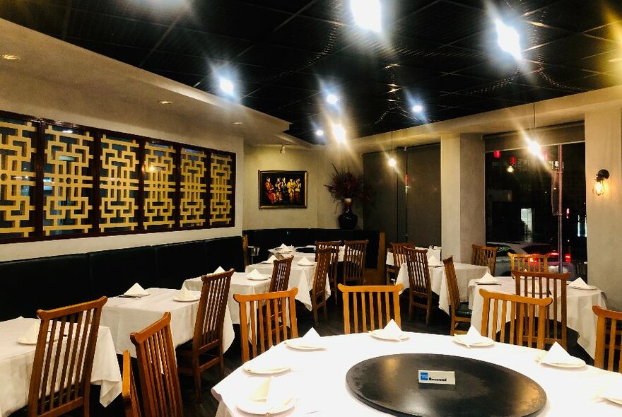 Chinese restaurant with white tablecloths and large circular table.