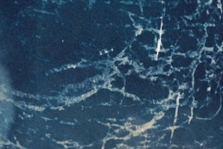 A close-up shot of a marbled blue and white surface.