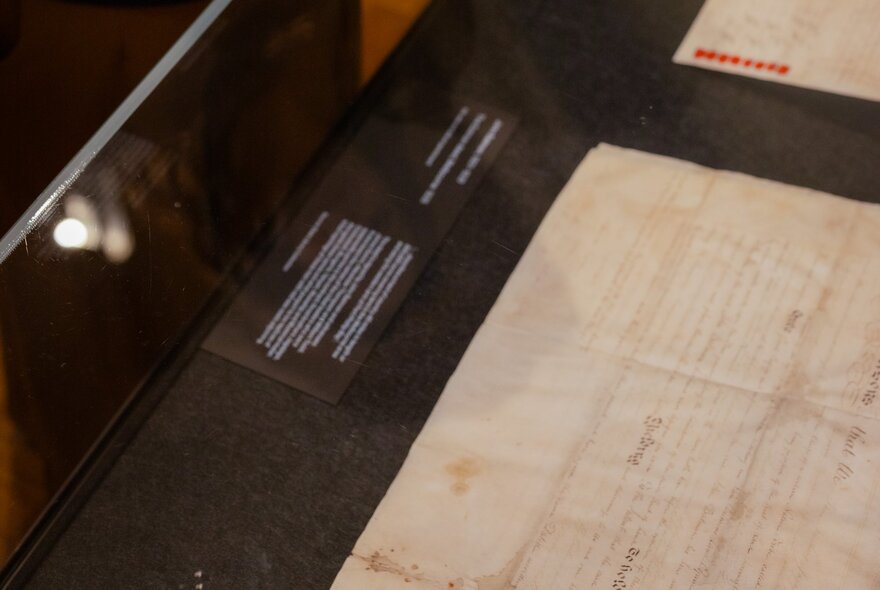An exhibition at the State Library Victoria, specifically designed to display the original 1835 treaty documents, shown here under a glass display case.