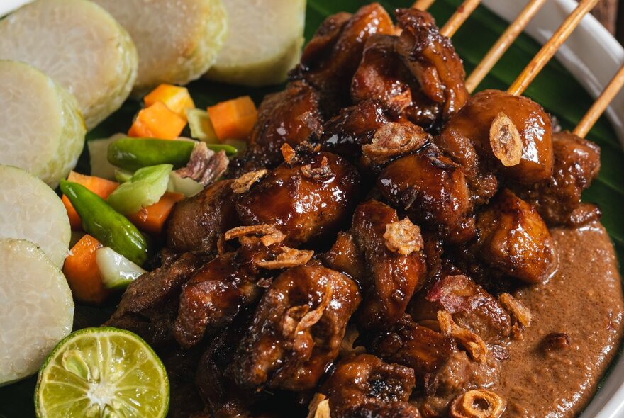 Indonesian satay, consististing of seasoned, skewered, and grilled meat. 