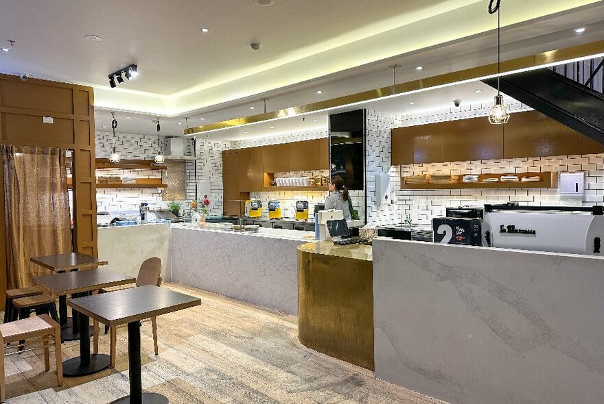 Cafe interior, clean white lines and wooden accents.