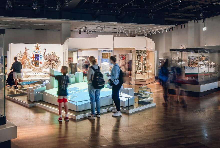 People looking at a lit up display in a glass cabinet at the Melbourne Museum.