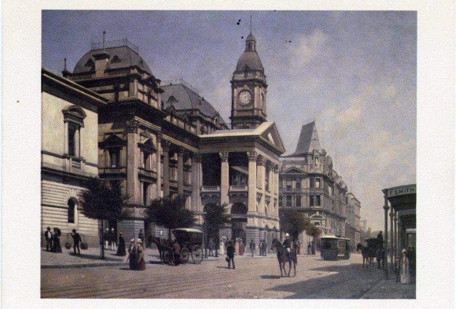 An old photo of a government building on a dirt road