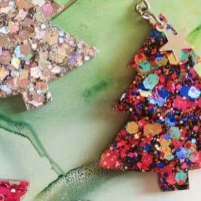 Christmas tree earrings made from colourful resin and sequins.