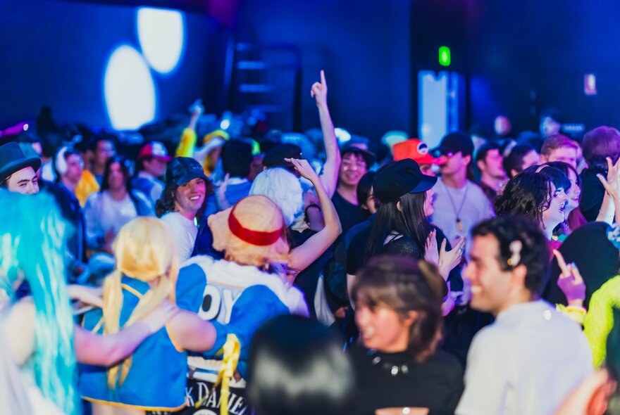 A cosplay anime rave with many people in costumes. 