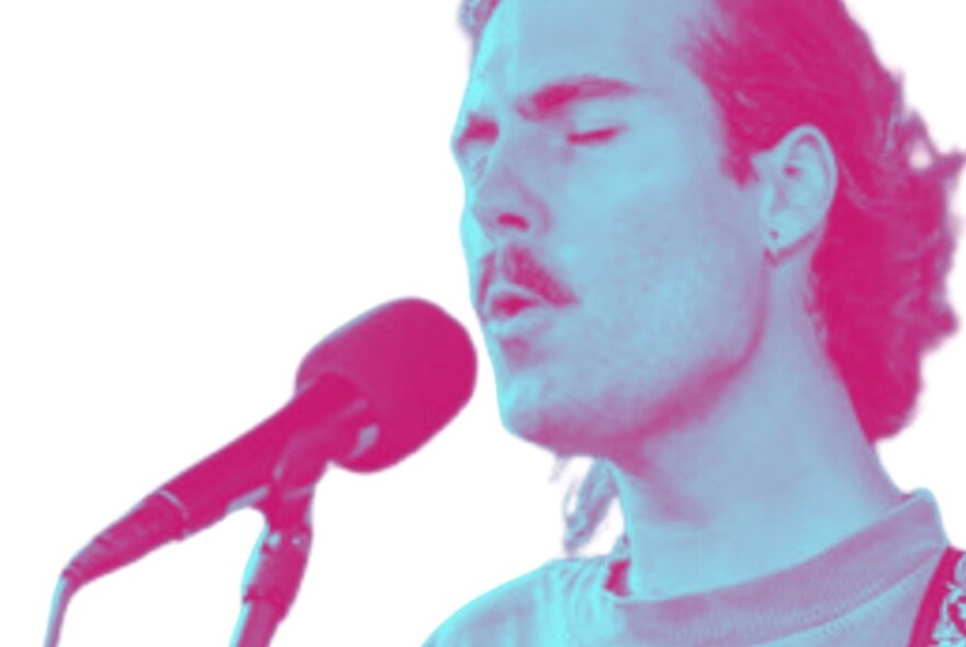 Pink and blue-coloured image of a mustachioed singer at a microphone with his eyes closed.