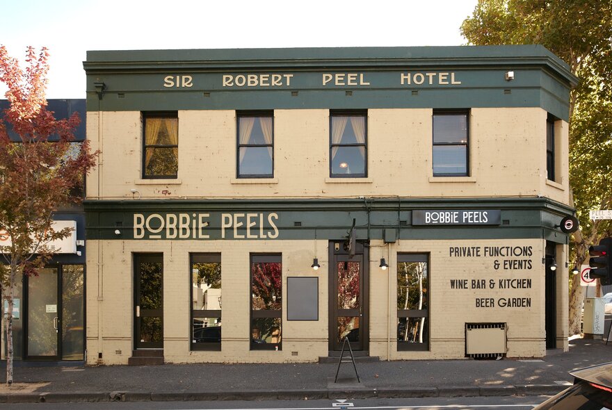 Bobbie Peels, a two-storey, Victorian-era pub with signage and windows, on a leafy corner.