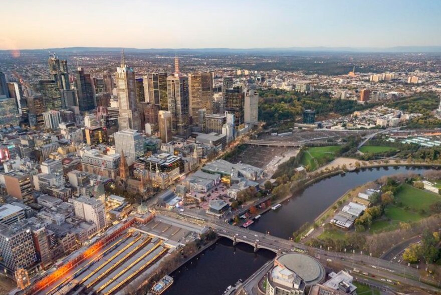 Melbourne from above looking over the Yarra River to the CBD skyscrapers and beyond.