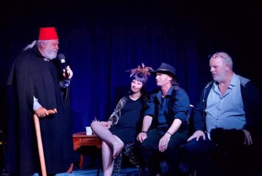 Comedians on stage performing a skit. 