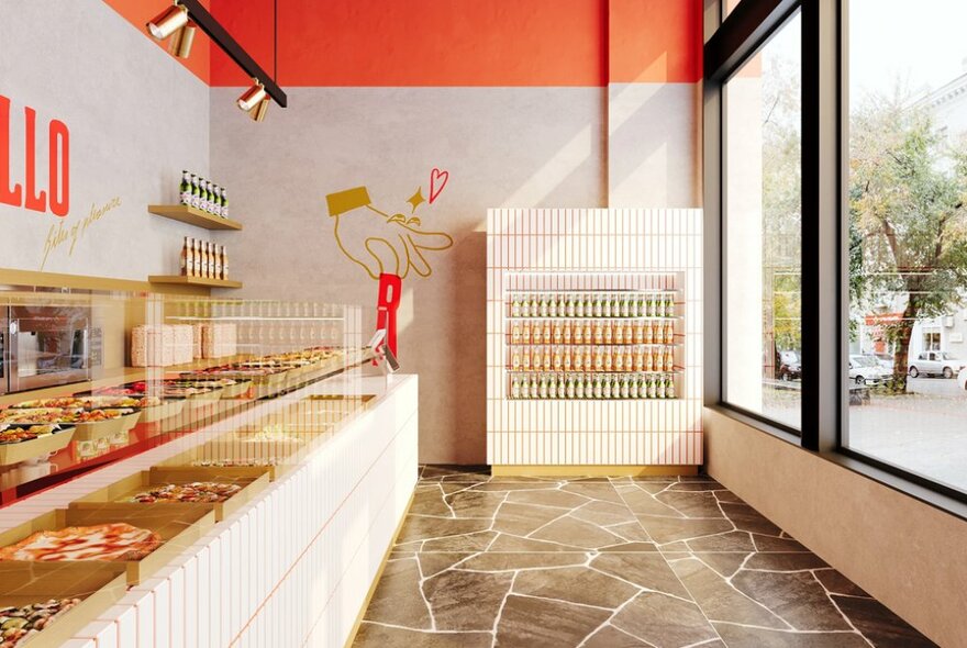 Interior of Romanello showing a long glass display counter of pizza, a drinks display  against the rear wall, a large window facing the street, a terrazzo floor and white and red walls. 