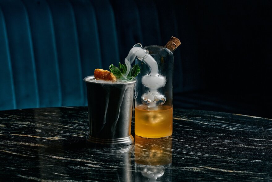 Scientific-themed cocktail with glass tube and bucket.