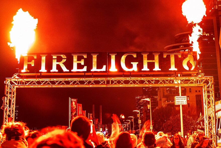 The entrance to the Firelight Festival at Docklands, with the words FIRELIGHT in large letters and flames on either side.