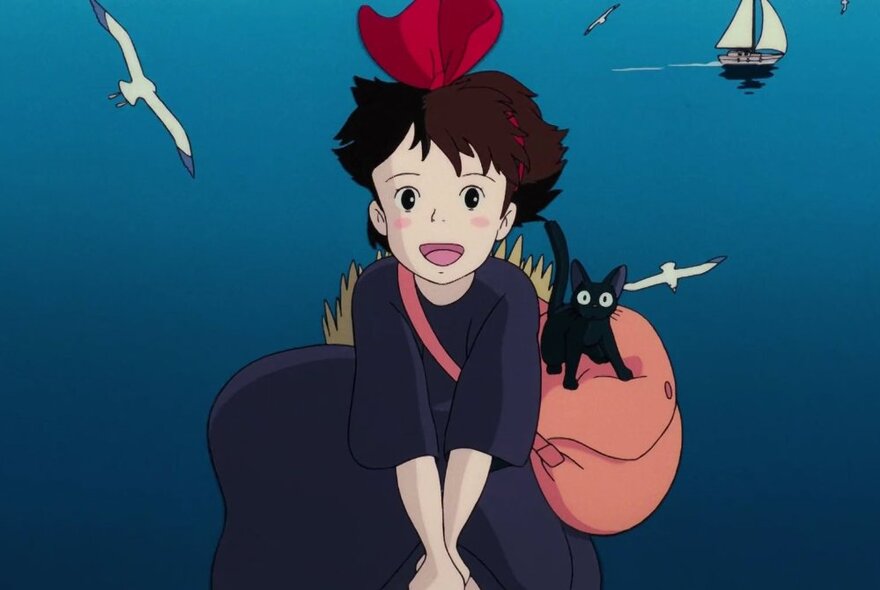 A still from an Japanese anime film showing a young child and a black cat on a pink cushion, against an ocean background.