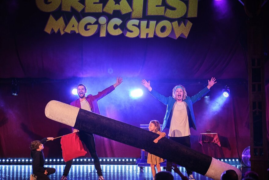 Two children's performers on stage performing a magic show.