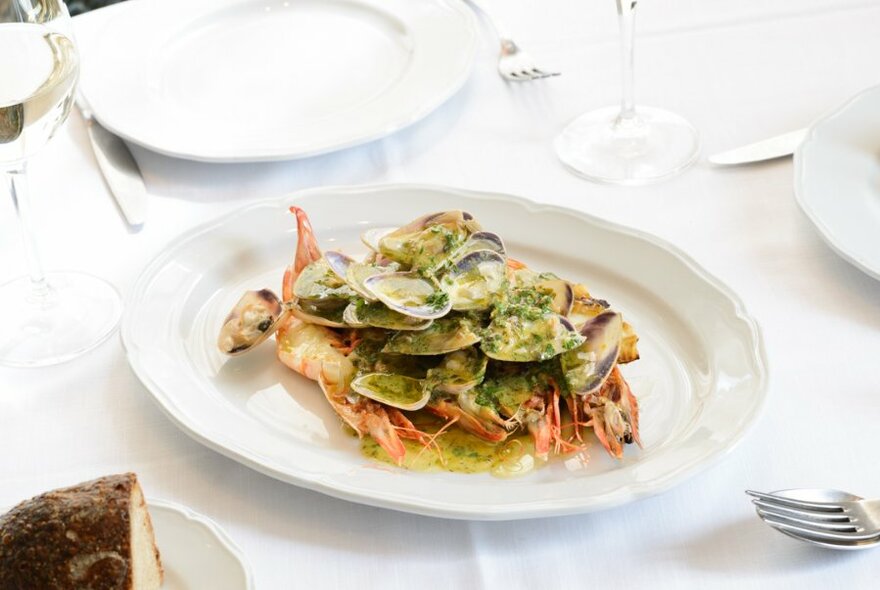 A fine dining table set with a seafood fish.