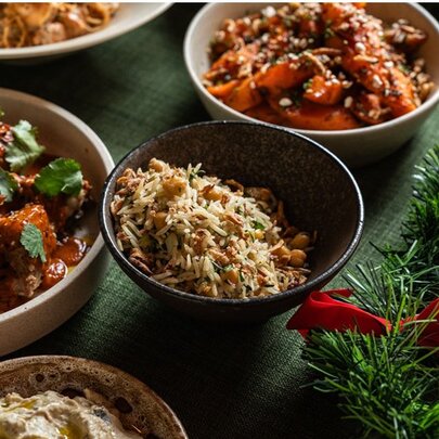 A spread of meat, rice, hummus and sweet potato. 