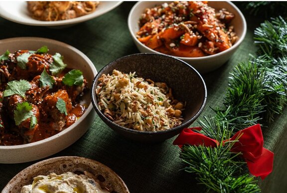 A spread of meat, rice, hummus and sweet potato. 