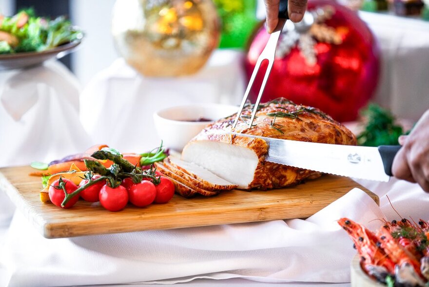 A spread of Christmas fare, including a roast chicken roll and vine-ripened cherry tomatoes.