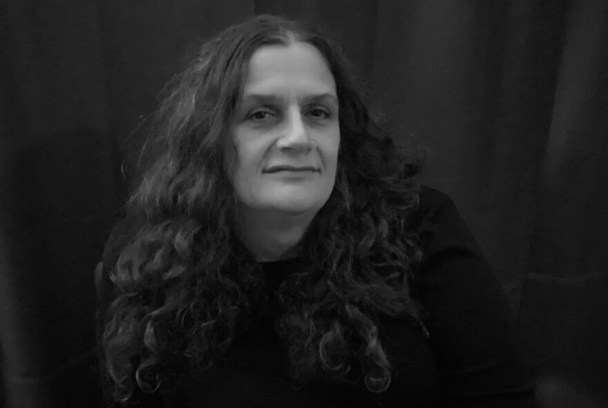A black and white head shot of Claire G. Coleman, smiling. 