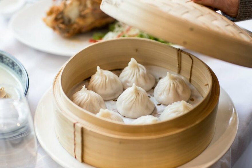 A steamer basket with dumplings in it