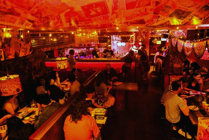 A crowd of people in a Mexican basement bar