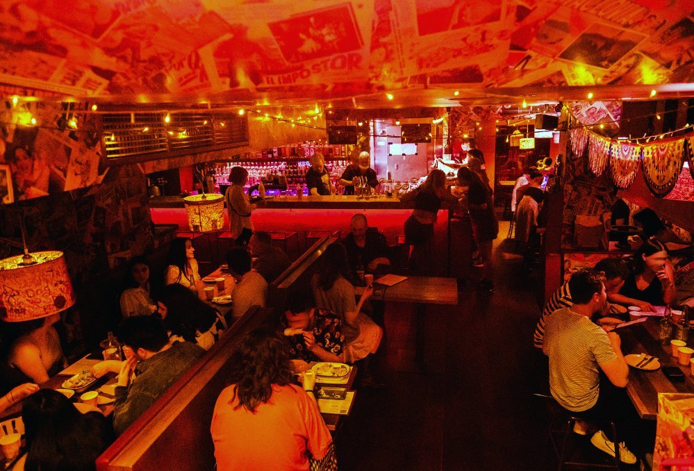 A crowd of people in a Mexican basement bar