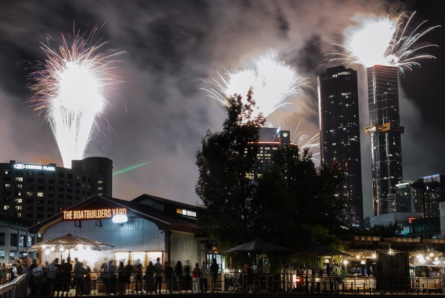 Fireworks going off against the Melbourne skyline. 