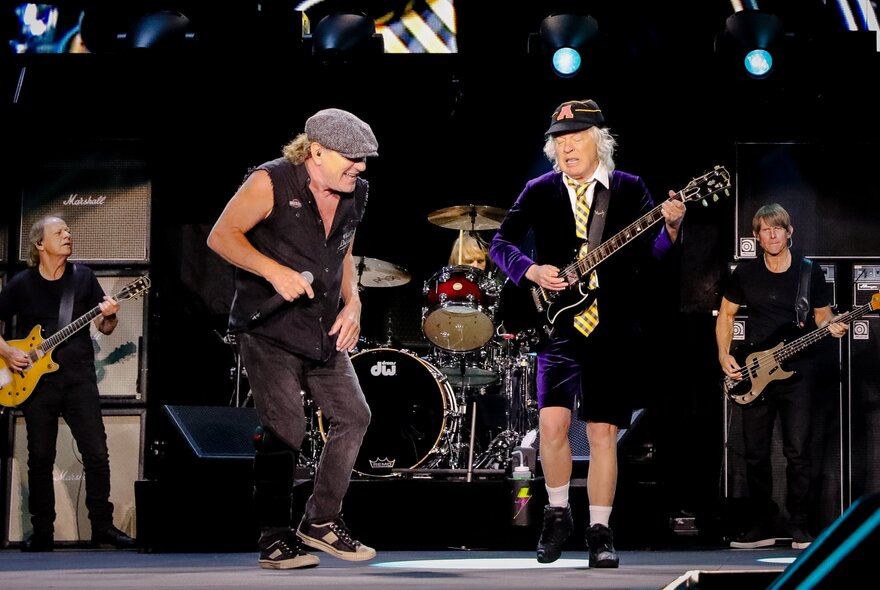 The band AC/DC playing a concert on stage.