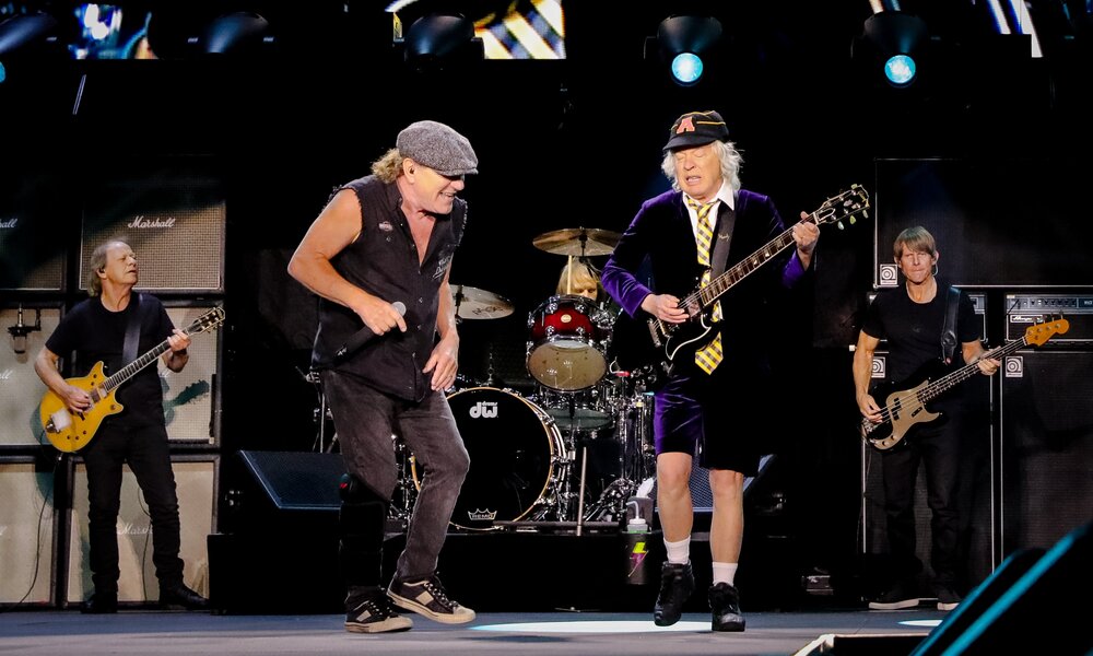 The band AC/DC playing a concert on stage.