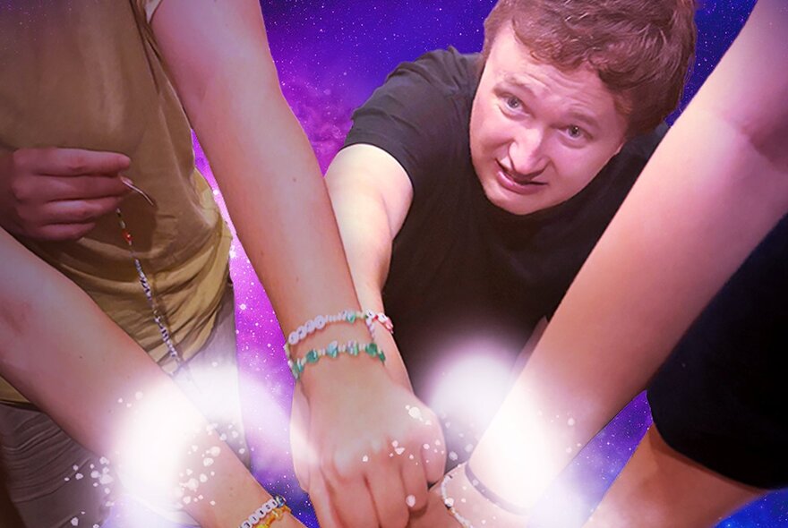 Scared-looking man giving his hand to a circle of hands, with eerie white light.