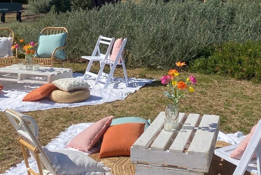 Picnic tables and chairs in a garden setting.