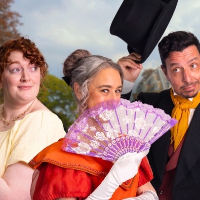 Three performers dressed in Regency outfits with fan, book and top hat.