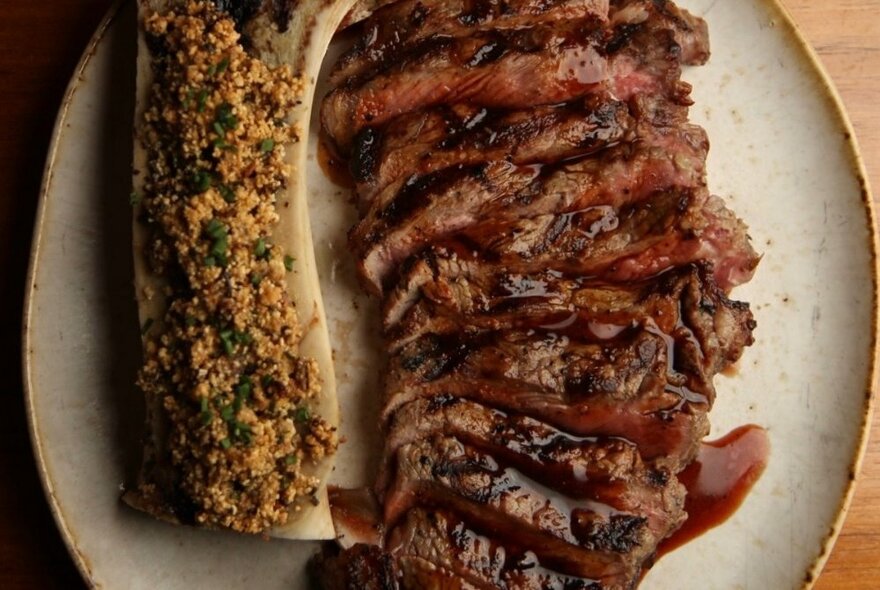 A plate of meat on a wooden table.